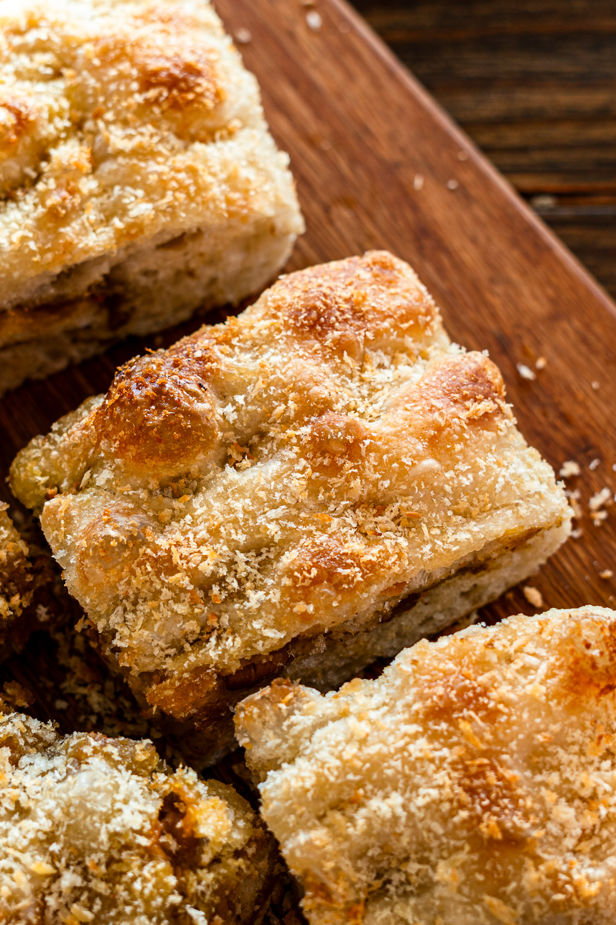 japanese curry focaccia topped with panko on a wooden cutting board