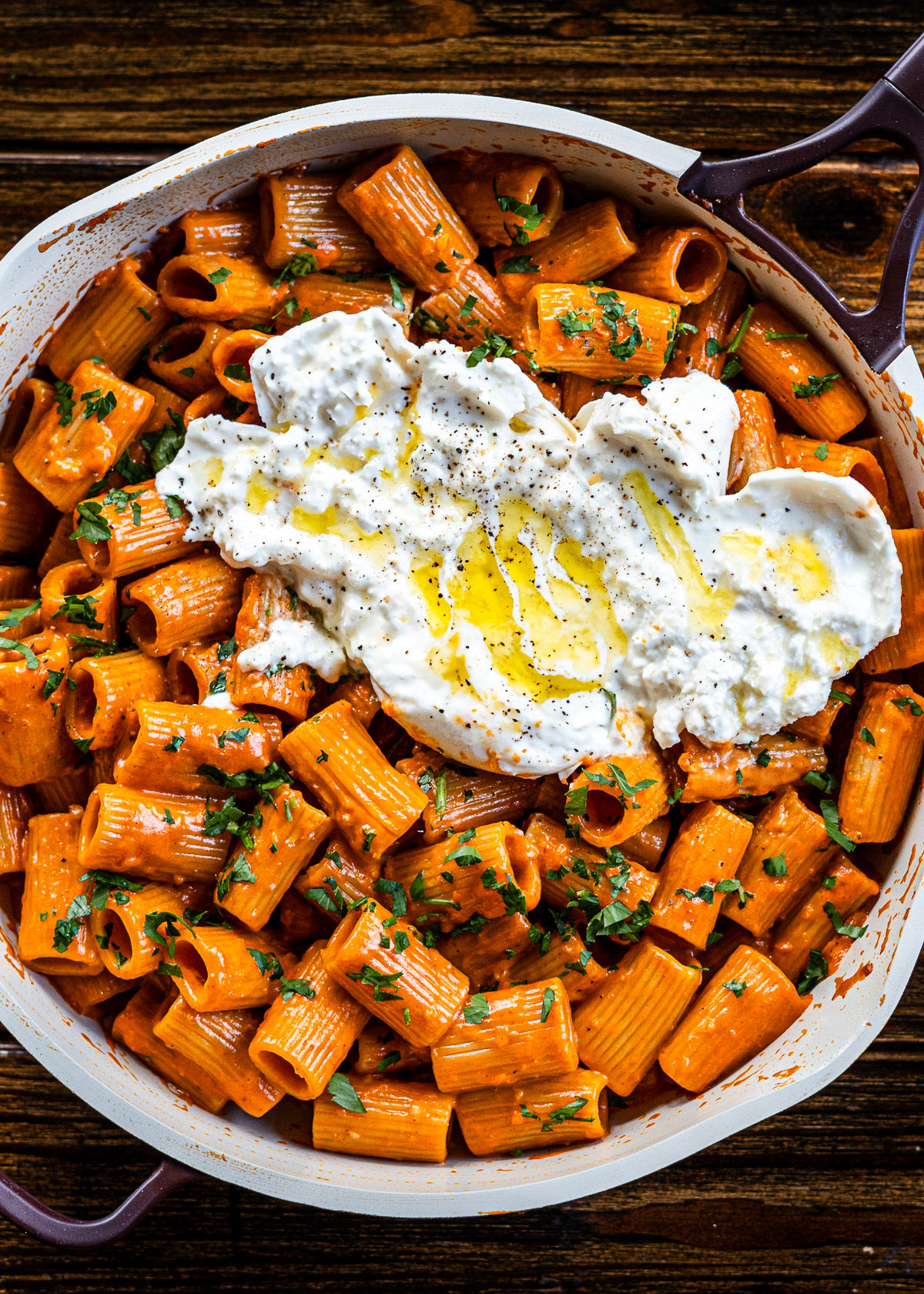 miso vodka pasta in a ourplace pan with burrata on top drizzled with olive oil