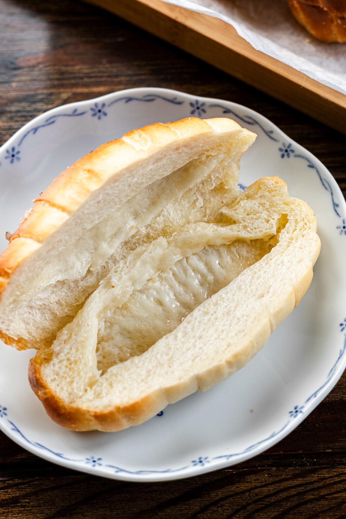 salt bread sliced in half with butter hole