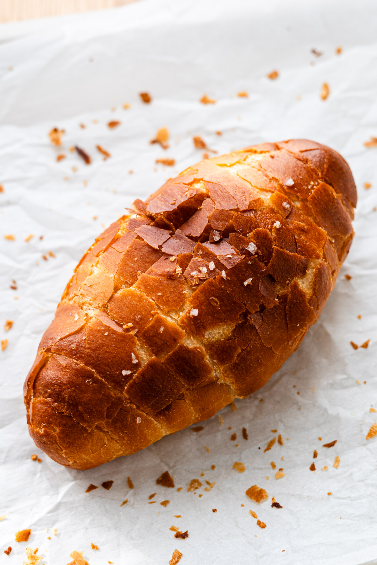 semi-hard crust salt bread with crackly crispy crust on a piece of parchment paper