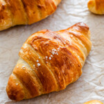 shio croissant topped with rock salt on parchment paper