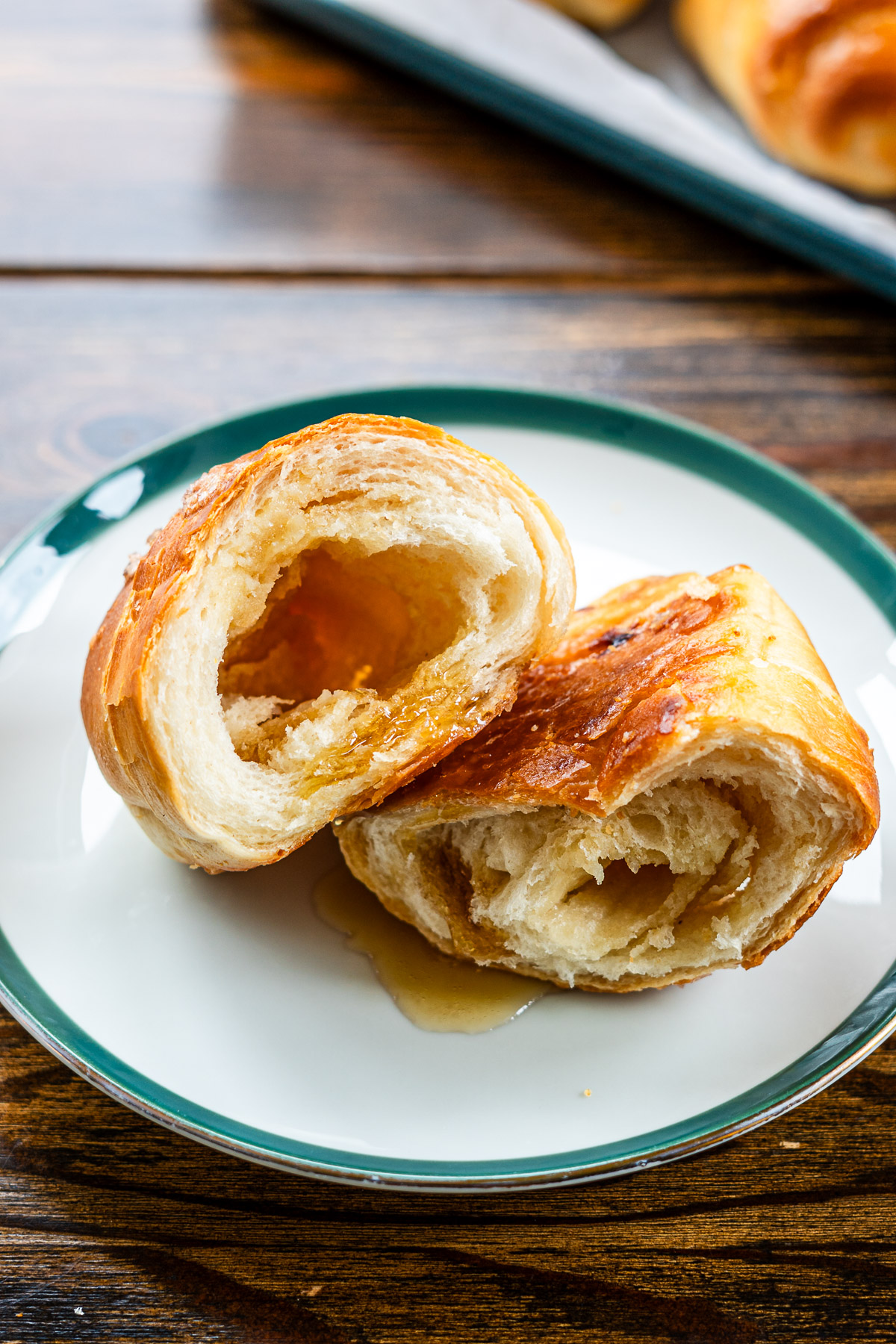 butter rolls with maple butter on a green rim plate