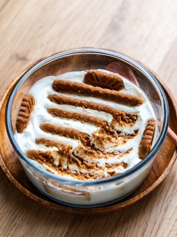 greek yogurt stuffed with biscoff cookies no bake cheesecake in a glass bowl