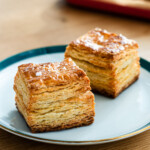 butter scones with layers of butter on a green rimmed plate