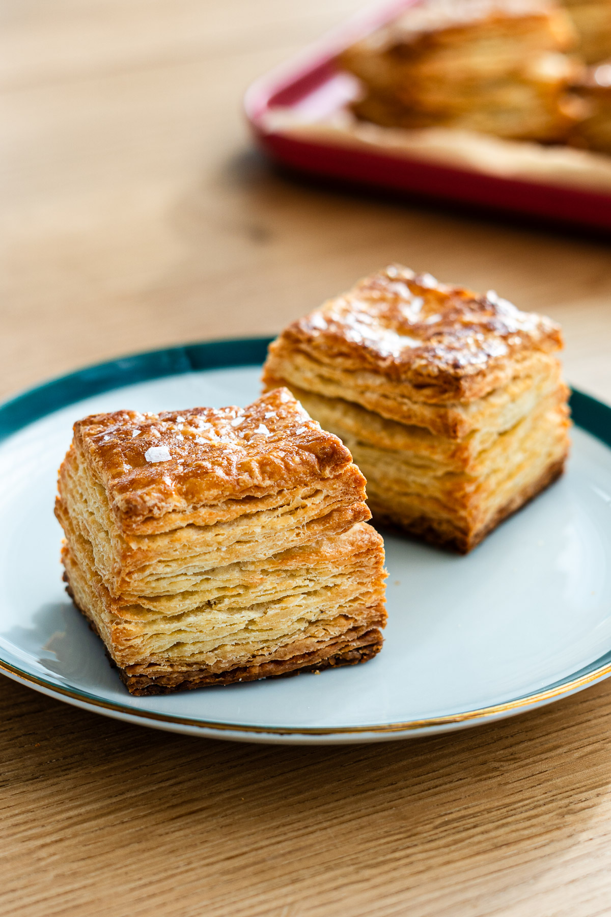 butter scones with layers of butter on a green rimmed plate