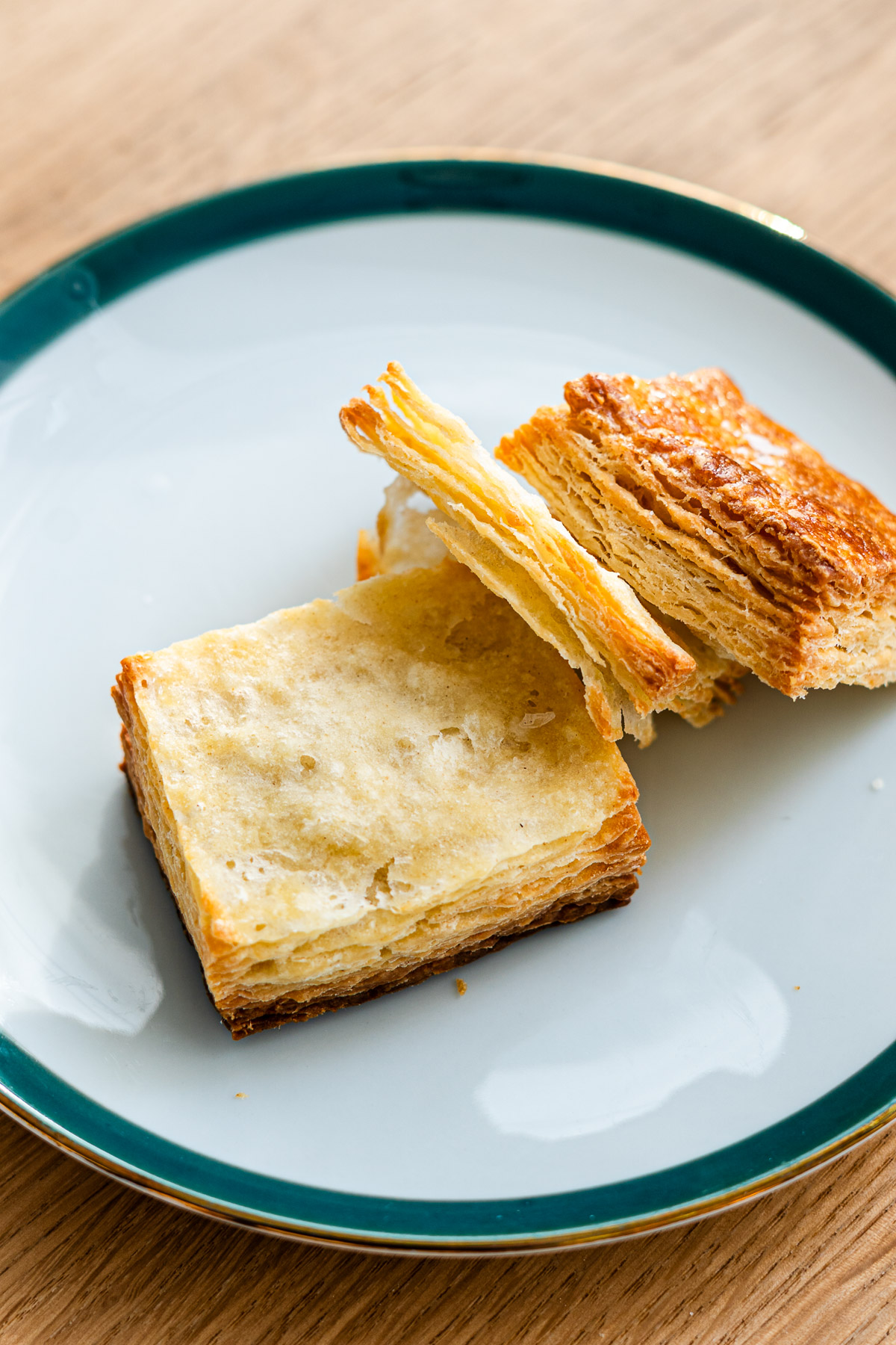 flaky laminated scones with layers, torn on a small dish