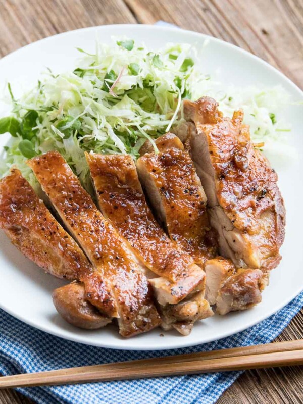 chicken teriyaki with thinly sliced cabbage on a white plate
