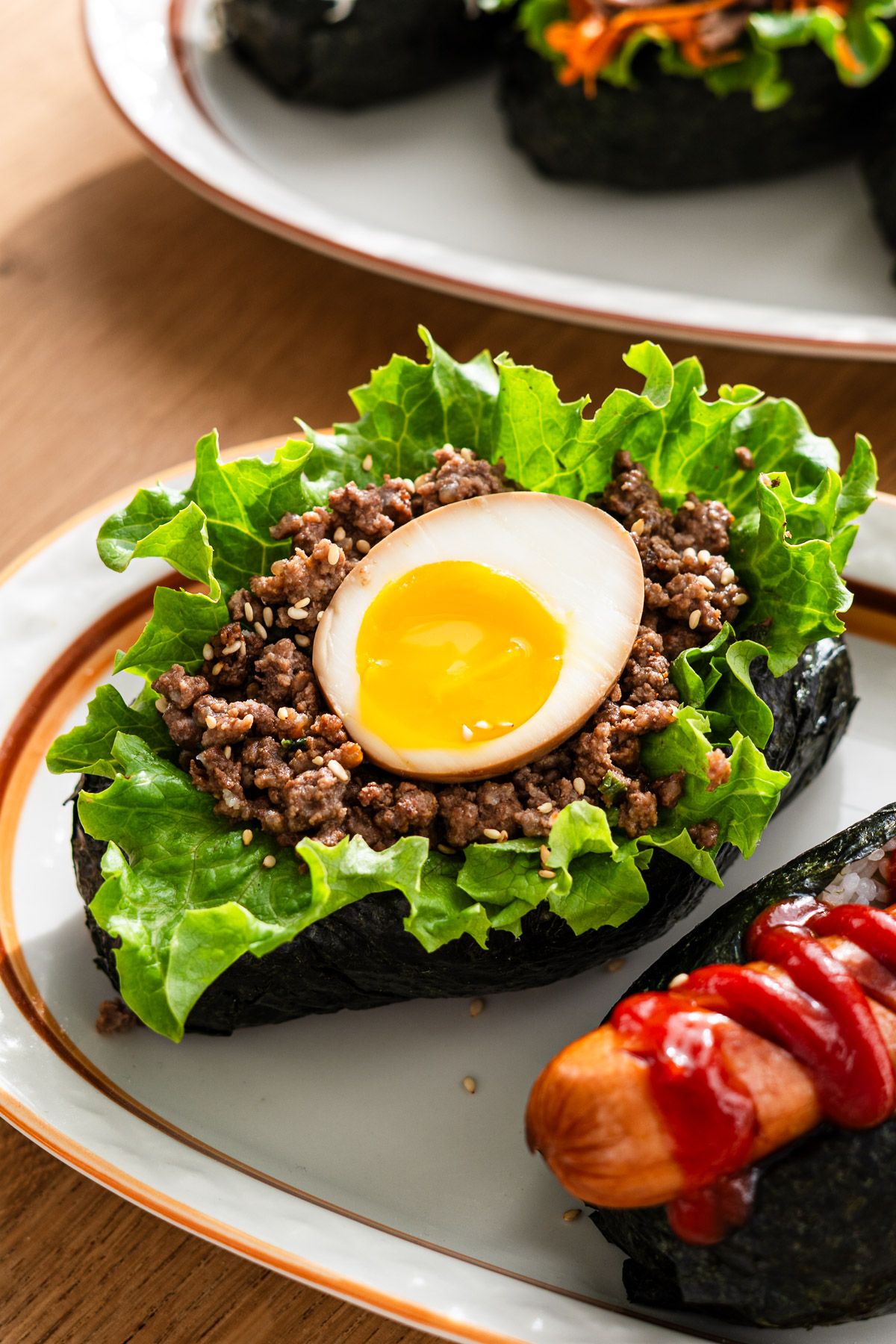 soft boiled egg, miso niku and lettuce on a onigiri hot dog