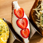 japanese fried cream sandwich with strawberries on a taco holder