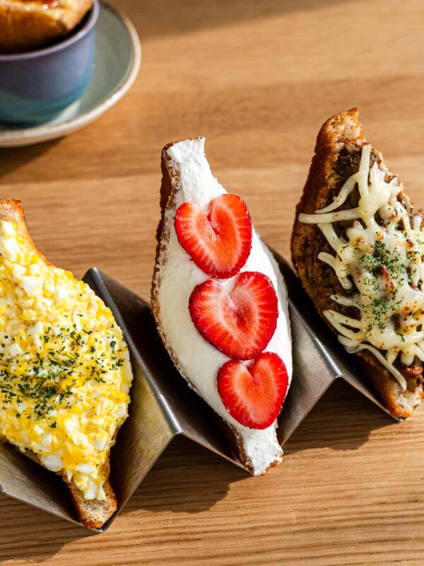 japanese fried whipped cream and fruit and egg salad filled sandwich on taco holders