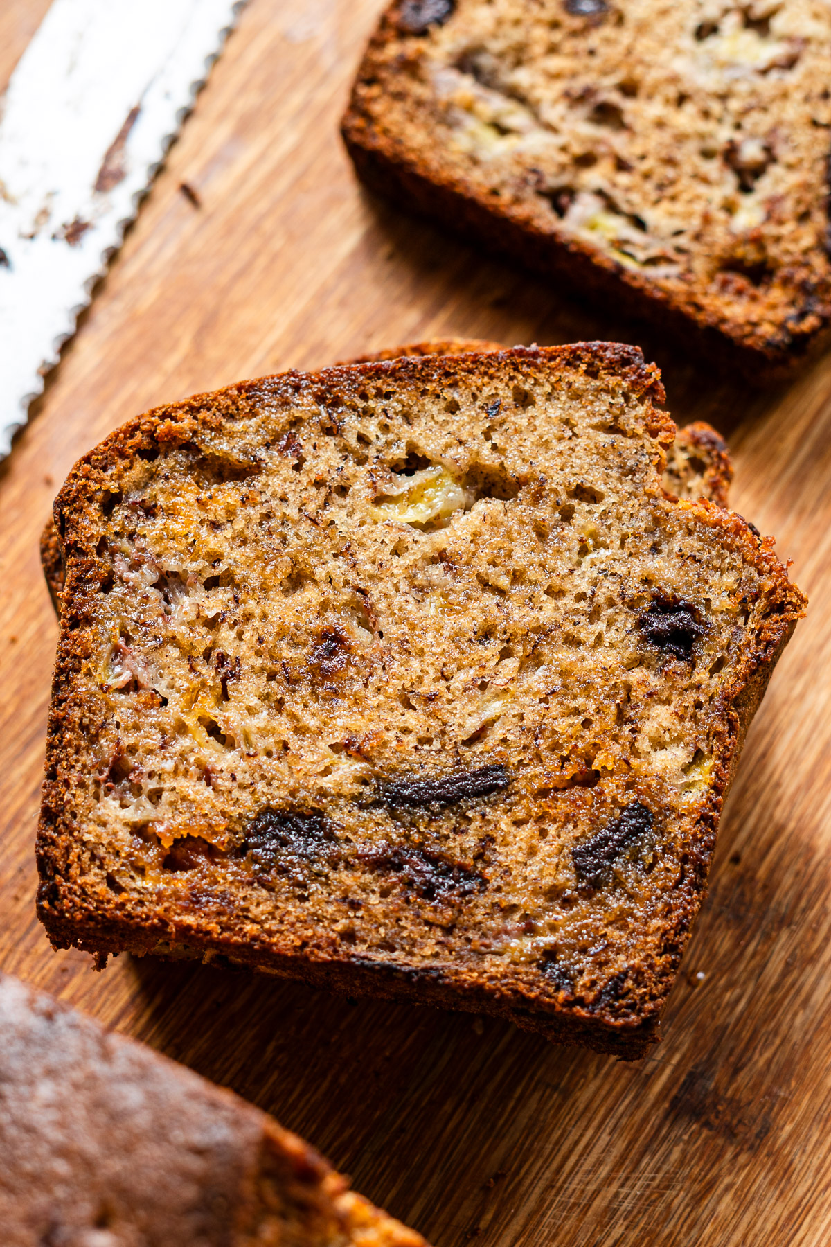 brown butter banana bread with chocolate chips on a wooden cutting board