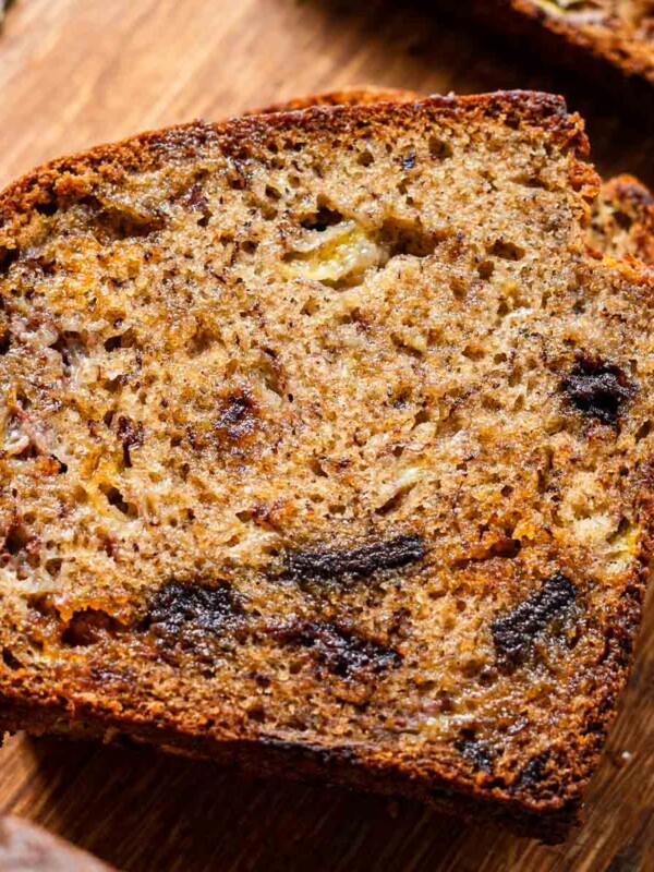 moist soft brown butter banana bread with chocolate chips on a wooden cutting board