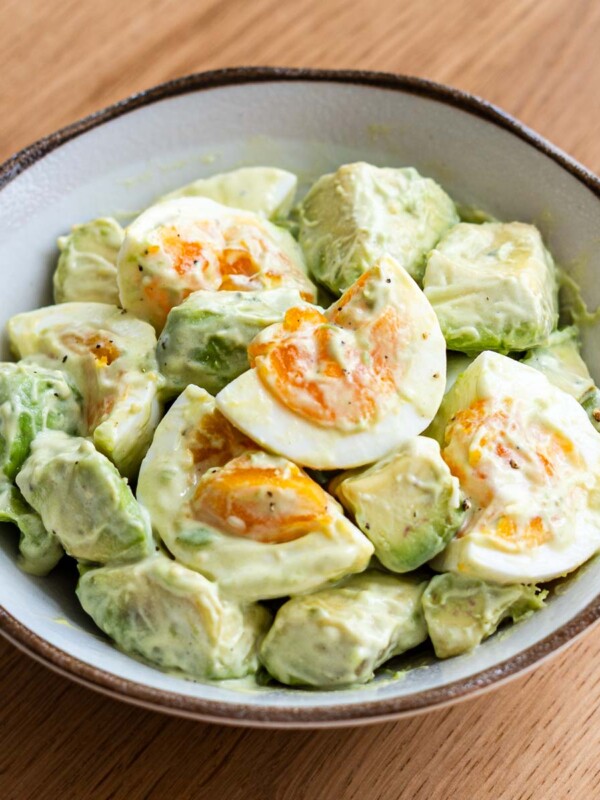 avocado egg salad in a brown rim side dish bowl coated in jaoanese mayo